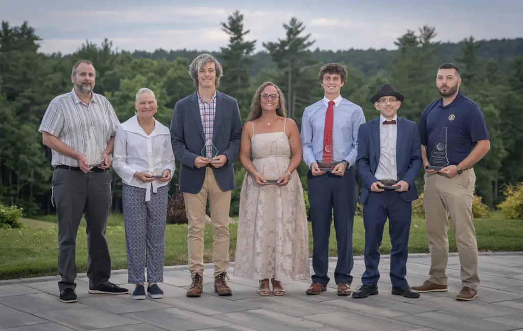 NAMI NH 2026 Annual Award winners standing as a group holding trophies
