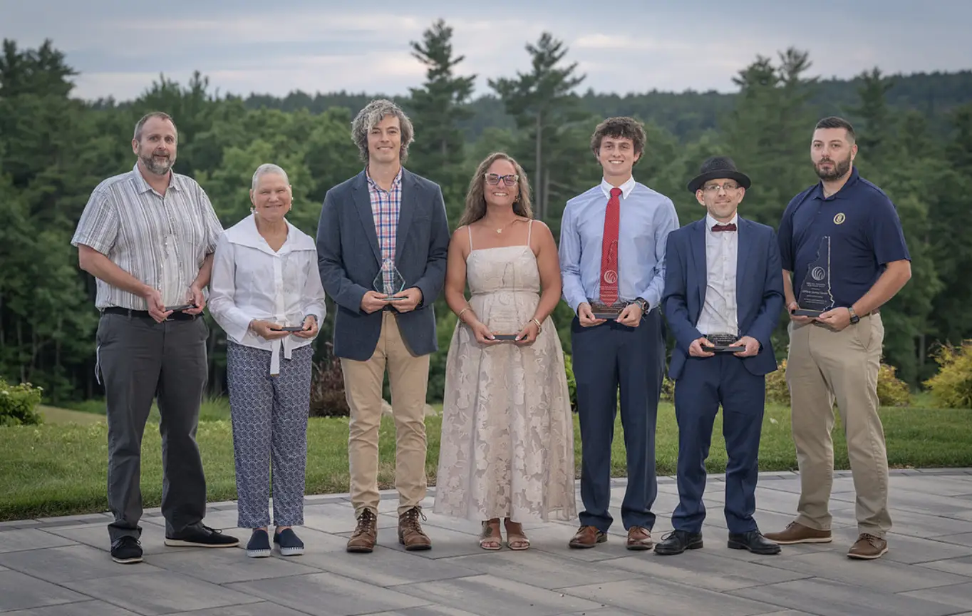 NAMI NH 2026 Annual Award winners standing as a group holding trophies